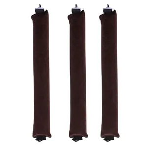 Close-up of three dark brown heatless hair rollers with soft velvet fabric and end clips