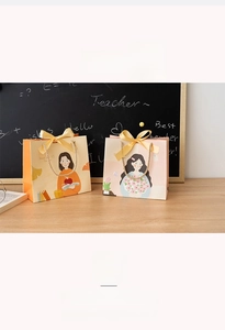Detail of teacher appreciation gift bags with festive illustrations and yellow ribbon bows
