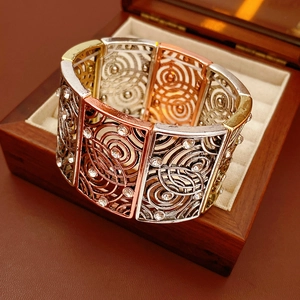 Close-up of vintage tricolor stretch bracelet with hollow circles and rhinestones