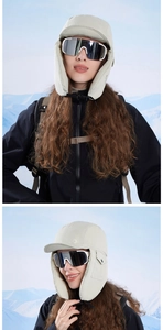 Detail of beige windproof trapper hat with ear flaps and buckle for winter outdoors