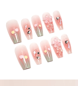 Macro view of long ballerina nails with 3D tulips, pink gradient, and silver rhinestones
