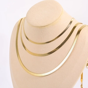Three-layer golden stainless steel flat snake chain necklaces on a mannequin display