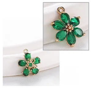 Macro detail of vintage emerald green zircon flower pendant with gold plated copper base