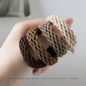 Set of four elastic woven hair ties in neutral brown and beige tones for ponytails