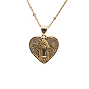 Golden heart pendant necklace featuring Virgin of Guadalupe relief and white cubic zirconia