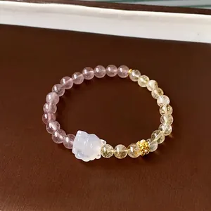 Elegant beaded crystal bracelet with white cat charm and golden flower on brown leather base