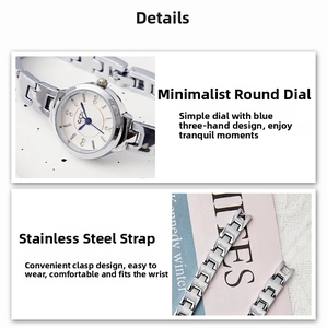 Detail view of silver alloy watch with blue hands and elegant metal chain bracelet