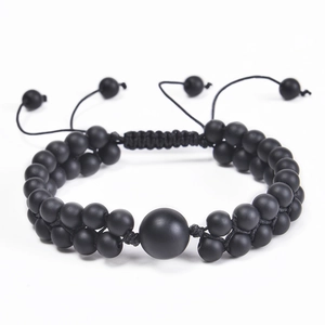 Detail of double-layer hand-woven bracelet with 6mm matte black beads and adjustable knot
