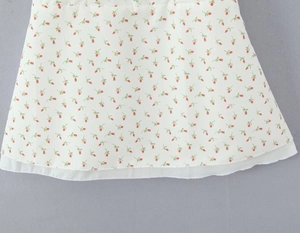 Detail of red floral print skirt hem with double-layered white lining and neat stitching