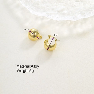 Detail shot of golden teardrop earrings showing 2cm height and 1.5cm width dimensions