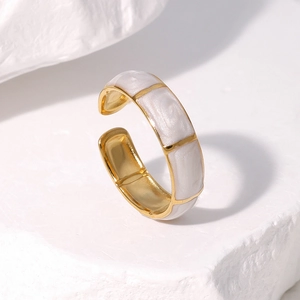 Macro detail of gold-plated bamboo joint ring with white enamel inlay and open band