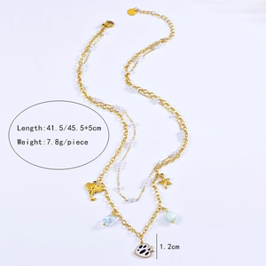 Detail showing layered gold necklace with starfish, elephant and pearl charms, 7.8g weight