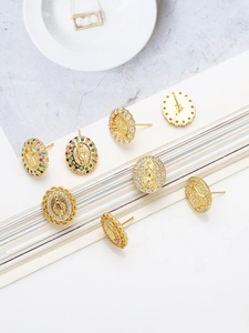Macro detail of vintage Virgin Mary stud earrings with gold plating and colorful zircons
