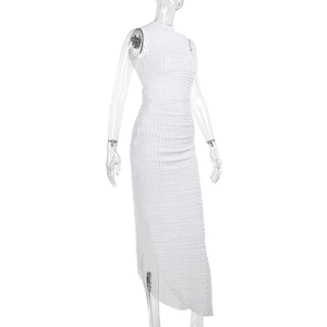 Close-up of white high-neck bodycon dress showing 3D textured fabric and sleeveless detail