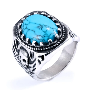 Macro view of vintage silver ring with turquoise stone and skull pattern engraving