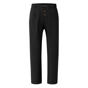 Detail of black linen trousers showing elastic drawstring waist and decorative wood button