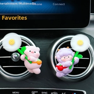 Cartoon pig and cow vent clips with spinning windmills on a car air outlet