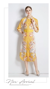 Full view of floral yellow midi dress with shirt collar and belt on professional model