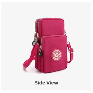 Side view of rose red nylon crossbody phone bag with three zippered compartments