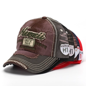 Close-up of washed denim baseball caps with Hawaii embroidery in multiple vintage colors