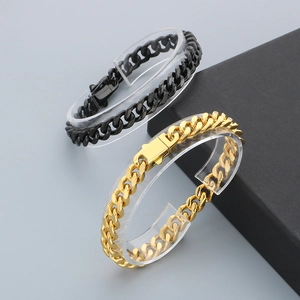 Detailed close-up of wide Cuban link bracelets in polished gold and black finishes