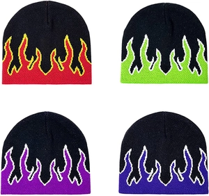 Detail view of four black knitted beanies with various colored jacquard flame patterns