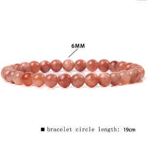 Detail view of 6mm red agate beads and 19cm elastic string for crystal bracelet