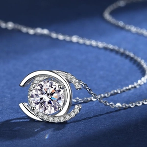 Close-up of a 2-carat round moissanite pendant with halo setting on a silver chain