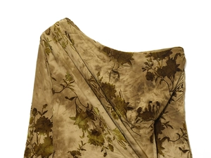 Detail of flocked floral pattern and ruched fabric on a one-shoulder dress