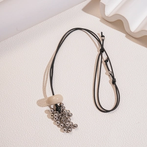 Retro wax cord necklace with beige resin ring and silver grape-style bead tassel pendant
