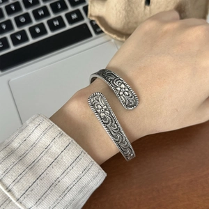 Silver vintage floral relief open bangle bracelet with intricate engraved flower patterns