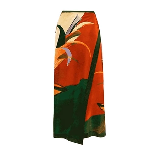 Close-up of tropical floral print maxi skirt with vibrant orange and green abstract patterns