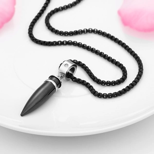 Detail of a black bullet cone pendant with small diamond inlay on a round box chain
