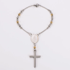 Detailed view of silver and gold rosary beads with Virgin Mary medal and cross pendant