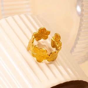 Golden flower stackable open ring made of durable stainless steel on ceramic decor