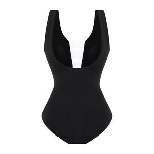 Detail of the back cutout featuring white straps on a black one-piece swimsuit