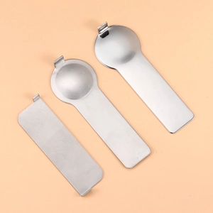 Flat lay of three stainless steel tools for Italian charm bracelets on beige background