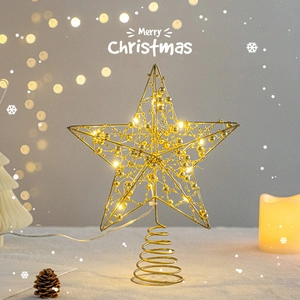 Luminous gold metal star Christmas tree topper with warm LED lights and a spiral base