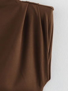 Macro shot of dark brown twill fabric showing detailed pleats and fine texture