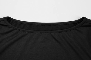 Close-up of a black knit dress showing round neckline stitching and fine fabric texture