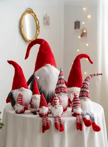 Close-up of assorted Christmas gnomes in various sizes with knitted hats and plush textures