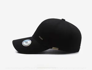 Side detail of black cotton twill baseball cap with metal narason logo plaque