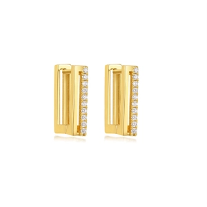Macro shot of U-shaped gold earrings with geometric cubic zirconia channel setting
