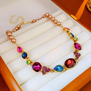 Detail of vintage French floral necklace with colorful gemstones and champagne pearls