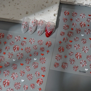 Detail of red and white 3D firework nail stickers with heart and star patterns