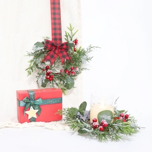 Detail of mini Christmas wreath with eucalyptus leaves, pine needles and red berries