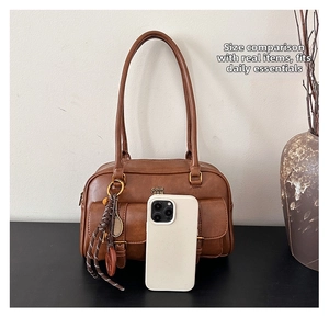 Brown vintage faux leather tote bag size comparison with a white smartphone