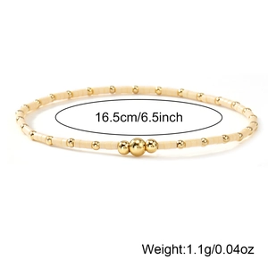 Handmade cream seed bead bracelet with gold metal spheres and 16.5cm length detail