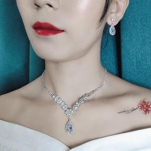 Bridal jewelry set with sparkling teardrop rhinestones and necklace worn by model