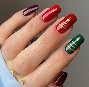 Detail of Christmas press-on nails with wine red, green colors and gold foil tree designs